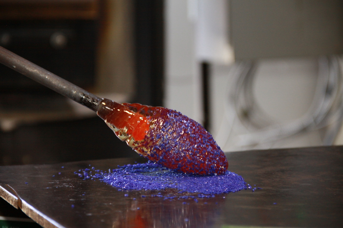 Molten glass being worked in Harmony Glassworks studio, from the official classes page